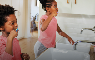 žena koja sedi ispred laptopa i smeje se